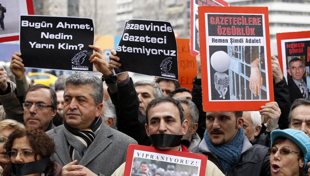Journalists and their supporters march as they protest against the arrests of journalists in Ankara